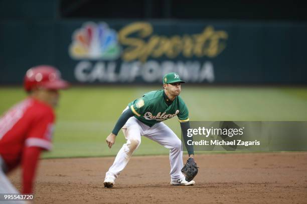 Chad Pinder of the Oakland Athletics fields during the game against the Los Angeles Angels of Anaheim at the Oakland Alameda Coliseum on June 15,...