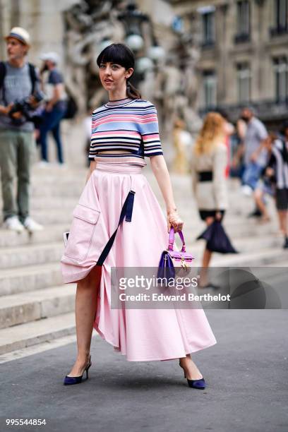 Guest wears a multicolor striped cropped t-shirt, a pink skirt, a purple and pink bag , outside Schiaparelli, during Paris Fashion Week Haute Couture...