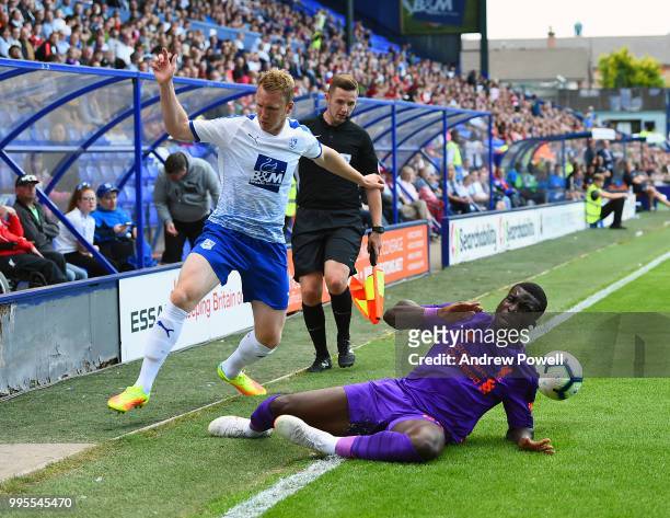 Sheyi Ojo of Liverpool competes with Jake Caprice of Tranmere Rovers during the pre-season friendly match between Tranmere Rovers and Liverpool at...