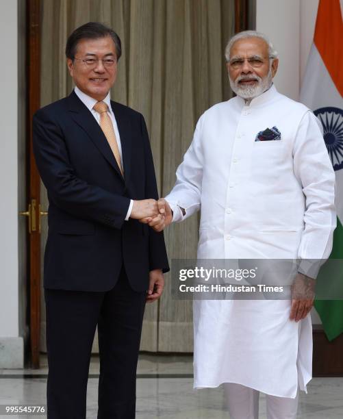 Prime Minister Narendra Modi with South Korean President Moon Jae-in shakes hand prior to their delegation level talk and signing of agreements at...