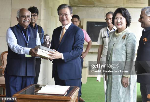 South Korean President Moon Jae-in and his wife Kim Jung-sook receive books on Mahatma Gandhi after paying homage at Rajghat, on July 10, 2018 in New...