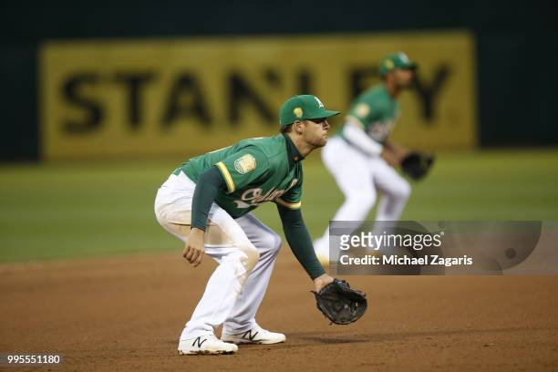 Chad Pinder of the Oakland Athletics fields during the game against the Los Angeles Angels of Anaheim at the Oakland Alameda Coliseum on June 15,...