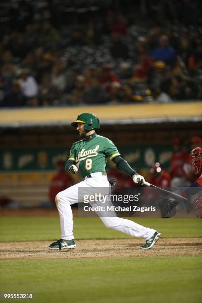 Jed Lowrie of the Oakland Athletics bats during the game against the Los Angeles Angels of Anaheim at the Oakland Alameda Coliseum on June 15, 2018...