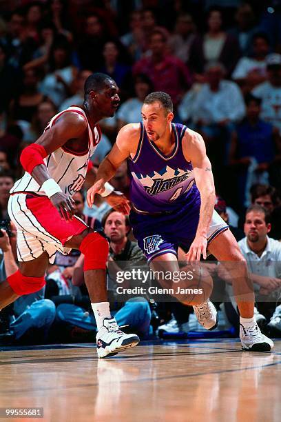 Greg Foster of the Utah Jazz drives against Hakeem Olajuwon of the Houston Rockets in Game Four of the Western Conference Finals during the 1997 NBA...