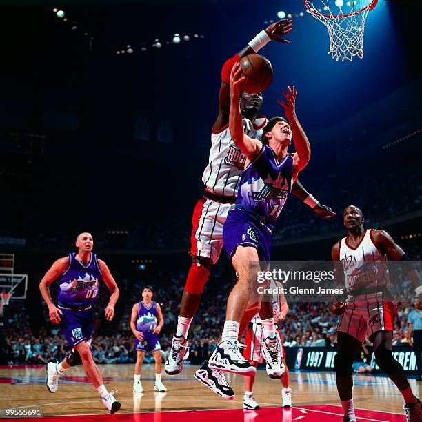 Jeff Hornacek of the Utah Jazz shoots a layup against Hakeem Olajuwon of the Houston Rockets in Game Four of the Western Conference Finals during the...