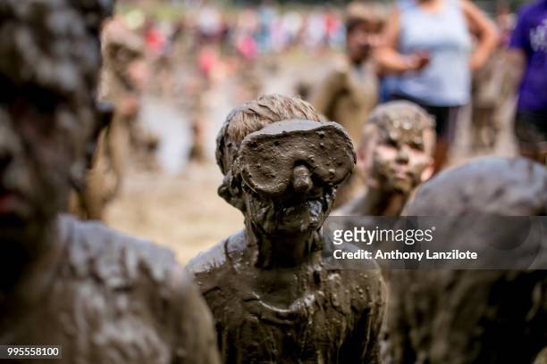 Boys line up to be judged in the King Mud contest at Mud Day at Nankin Mills Park on July 10, 2018 in Westland, Michigan. The event has taken place...