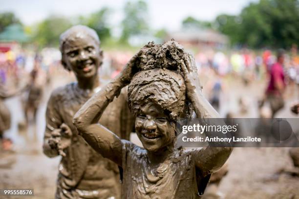 Children play in the mud at Mud Day at Nankin Mills Park on July 10, 2018 in Westland, Michigan. The event has taken place for the past 31 summers...