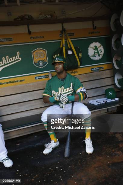 Khris Davis of the Oakland Athletics sits in the dugout during the game against the Los Angeles Angels of Anaheim at the Oakland Alameda Coliseum on...