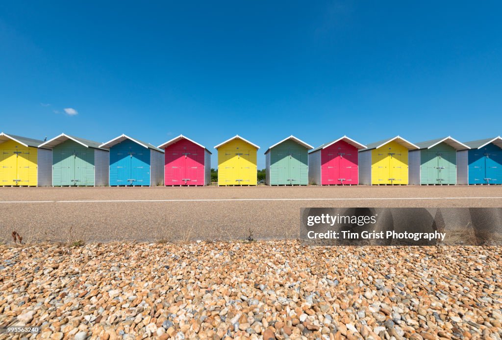 A Row of Multi-Coloured Beach Huts along the Promenade, Eastbourne, East Sussex