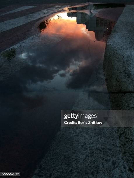 sunset reflection. - puddle reflection stock pictures, royalty-free photos & images