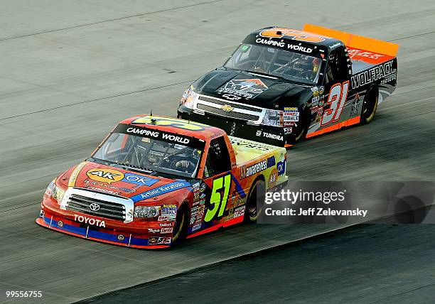 Aric Almirola, driver of the Graceway Pharm/AKawareness.com Toyota, leads James Buescher, driver of the Wolf Pack Rentals Chevrolet during the NASCAR...