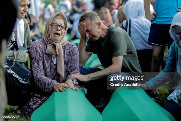 People mourn as coffins of 35 victims of 1995 Srebrenica massacre are carried to Potacari memorial cemetery for service to mark the 23rd anniversary...