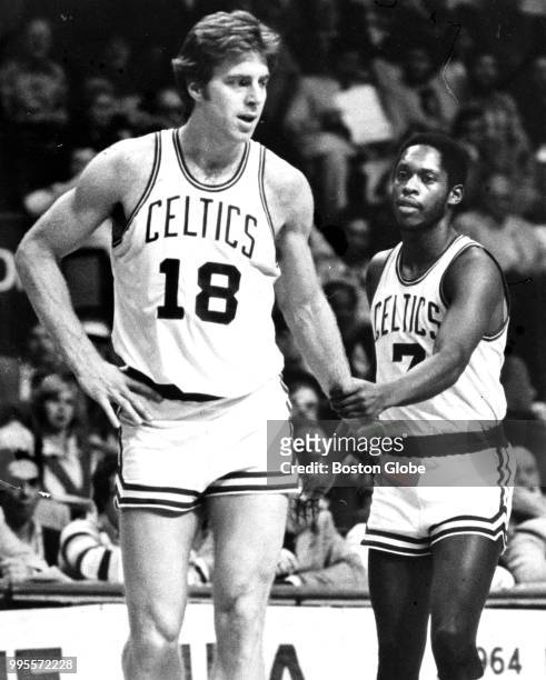 Boston Celtics' Nate "Tiny" Archibald, right, tries to calm teammate Dave Cowens after Cowens picked up a pair of fouls during the second quarter....