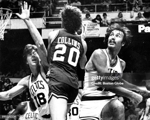 Boston Celtics' Chris Ford, right, fouls Philadelphia's Doug Collins as he tries to shoot, while the Celtics' Dave Cowens guards at left, during the...