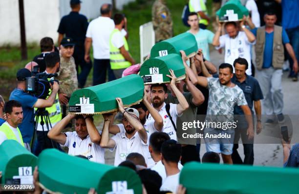 Bosnians carry the coffins of the 35 Srebrenica victims to the Potocari Monument Cemetery to pay respect during the 23rd anniversary of the massacre...