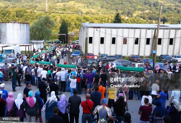 Bosnians carry the coffins of the 35 Srebrenica victims to the Potocari Monument Cemetery to pay respect during the 23rd anniversary of the massacre...