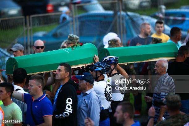 Bosnians carry the coffins of the 35 Srebrenica victims to the Potocari Monument Cemetery to pay respect during the 23rd anniversary of the massacre...