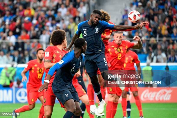 France's defender Samuel Umtiti heads the ball to score the opening goal during the Russia 2018 World Cup semi-final football match between France...
