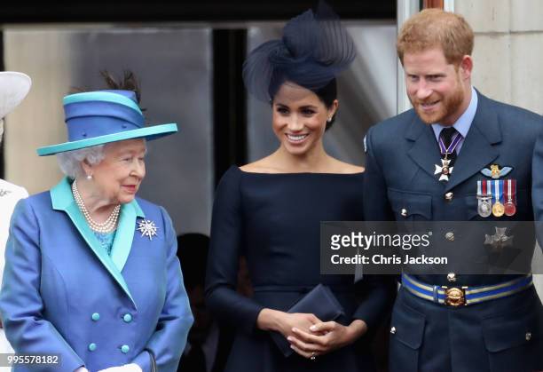 Queen Elizabeth II, Meghan, Duchess of Sussex, Prince Harry, Duke of Sussex watch the RAF flypast on the balcony of Buckingham Palace, as members of...