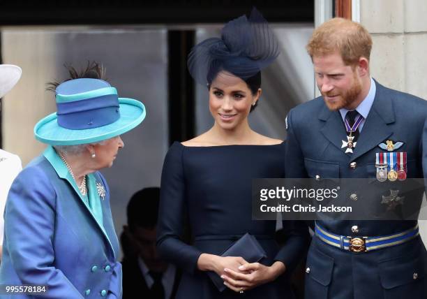 Queen Elizabeth II, Meghan, Duchess of Sussex, Prince Harry, Duke of Sussex watch the RAF flypast on the balcony of Buckingham Palace, as members of...
