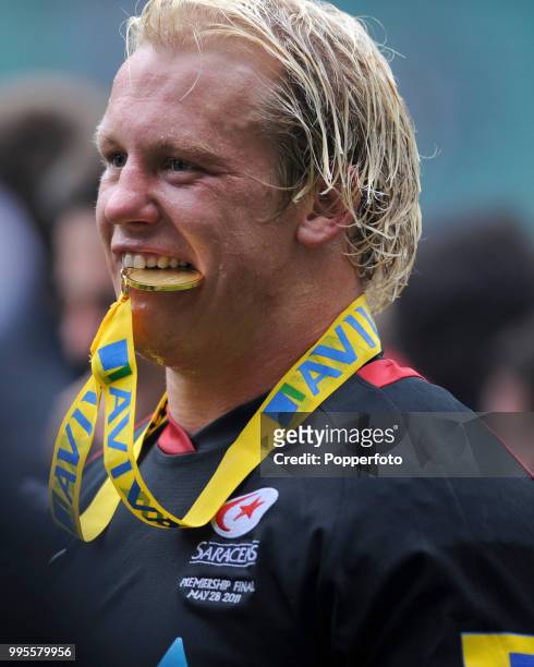 Petrus Du Plessis of Saracens chews his victory medal following the AVIVA Premiership Final between Leicester Tigers and Saracens at Twickenham...