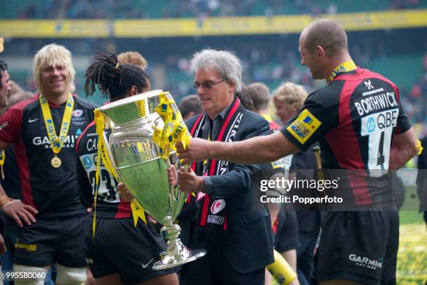 Saracens' owner Nigel Wray holds the trophy following the AVIVA Premiership Final between Leicester Tigers and Saracens at Twickenham Stadium in...