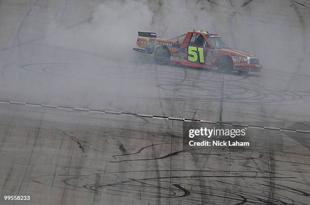 Aric Almirola, driver of the Graceway Pharm/AKawareness.com Toyota, celebrates winning the NASCAR Camping World Truck Series Dover 200 at Dover...