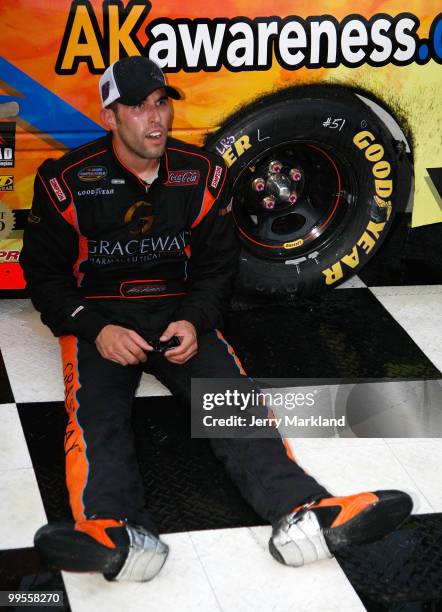 Aric Almirola, driver of the Graceway Pharm/AKawareness.com Toyota, sits in Victory Lane after winning the NASCAR Camping World Truck Series Dover...