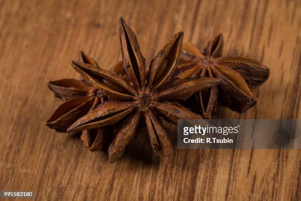 star of anise on rustic wood background - rustic star stock-fotos und bilder
