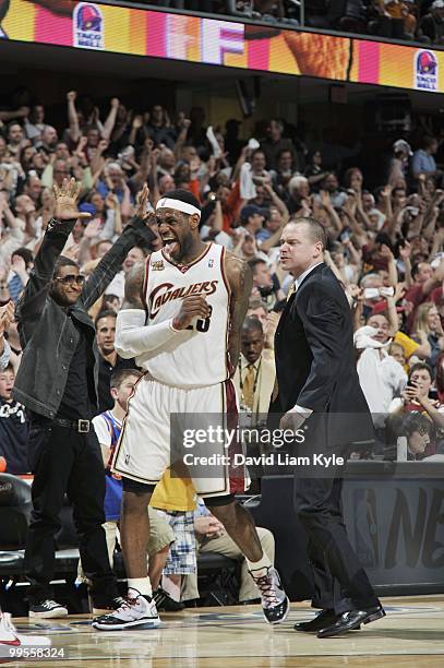 LeBron James of the Cleveland Cavaliers celebrates in front of musician Usher in Game One of the Eastern Conference Semifinals against the Boston...