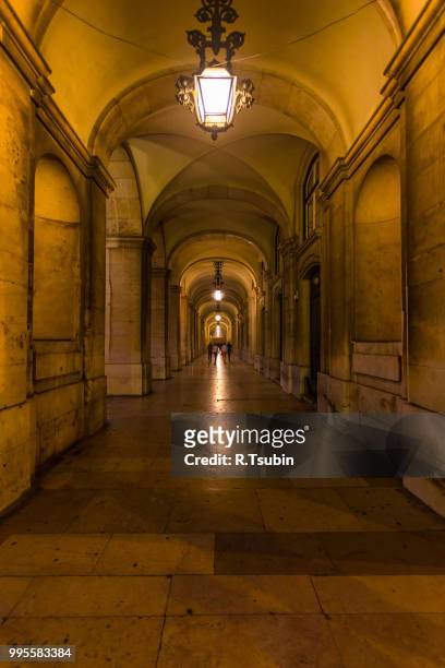 archway during evening in the commerce square. lisbon, portugal - rua stock pictures, royalty-free photos & images