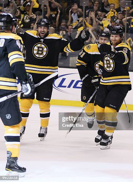 Johnny Boychuk, Miroslav Satan and Dennis Wideman of the Boston Bruins celebrate Milan Lucic's goal in the first period against the Philadelphia...