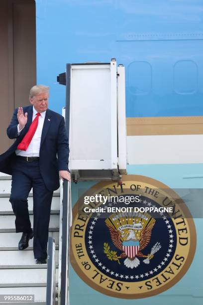 President Donald Trump waves as he disembarks from Air Force One as he arrives at Melsbroek Air Base in Haachtsesteenweg on July 10, 2018. - US...