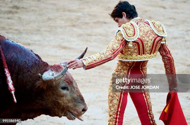 French matador Sebastian Castella touches the horn of a Fuente Ymbro fighting bull during a bullfight of the San Fermin festival in Pamplona,...