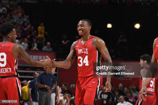 Antonio Blakeney exchanges a high five with Wendell Carter Jr., #34 of the Chicago Bulls during the game against the the Cleveland Cavaliers during...