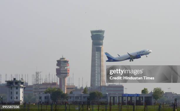 Passenger aircraft seen flying over new ATC Tower at Terminal 3 of Indira Gandhi International Airport on July 8, 2018 in New Delhi, India.