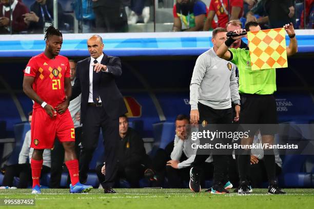 Head Coach of Belgium Roberto Martinez talks with Michy Batshuayi of Belgium before introducing him as a substitute during the 2018 FIFA World Cup...