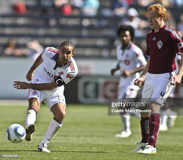 Dwayne De Rosario of Toronto FC passes the ball to a teammate in front of Jeff Larentowicz of the Colorado Rapids during the first half at Dick's...