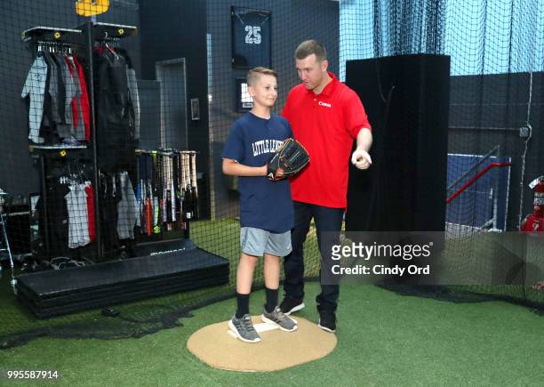 Todd Frazier and a player from the the Toms River Little League at the Canon #PIXMAPerfect Grand Slam event at New York Empire Baseball on July 10,...