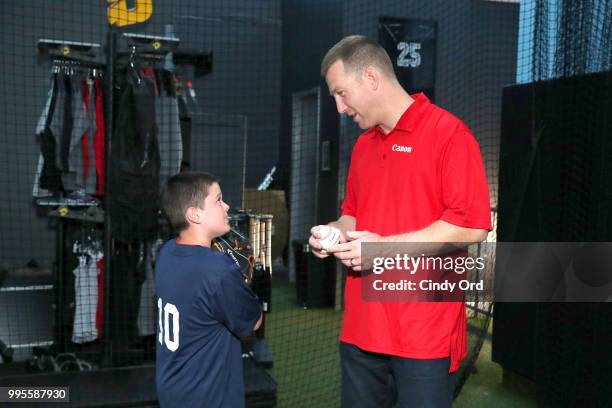 Todd Frazier and a player from the the Toms River Little League at the Canon #PIXMAPerfect Grand Slam event at New York Empire Baseball on July 10,...