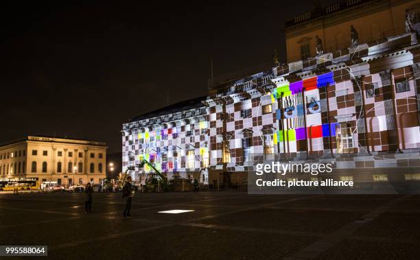 Dpatop - The restored building of the Staatsoper Unter den Linden is illuminated during a rehearsal for the Festival of Lights in Berlin, Germany, 26...