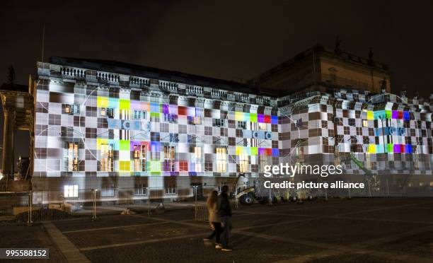 The restored building of the Staatsoper Unter den Linden is illuminated during a rehearsal for the Festival of Lights in Berlin, Germany, 26...
