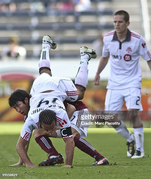 Kosuke Kimura of the Colorado Rapids upends Dwayne De Rosario of Toronto FC during the first half at Dick's Sporting Goods Park on April 18, 2010 in...