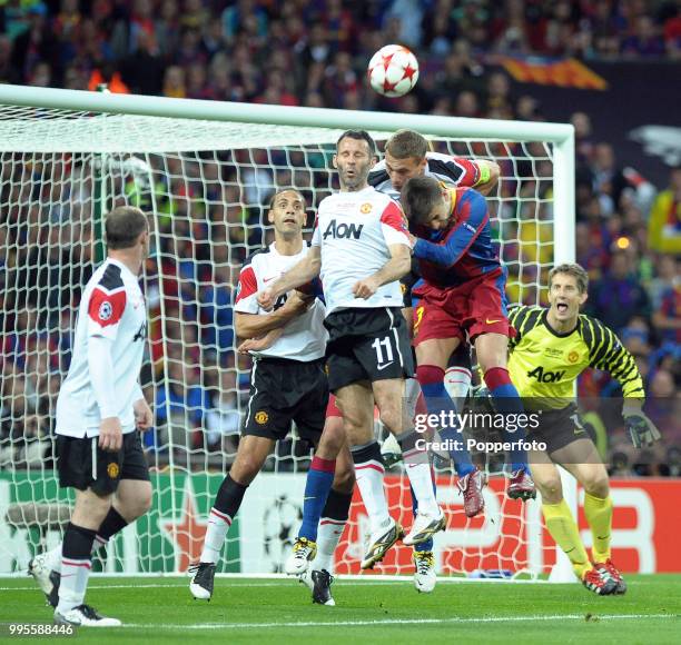 Left to right: Ryan Giggs, Nemanja Vidic and Rio Ferdinand of Manchester United and Gerard Pique of FC Barcelona in action during the UEFA Champions...