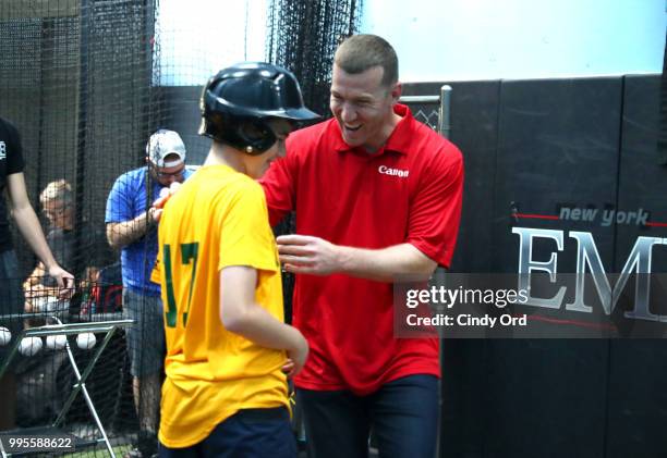 Todd Frazier and a player from the the Greenwich Village Little League at the Canon #PIXMAPerfect Grand Slam event at New York Empire Baseball on...