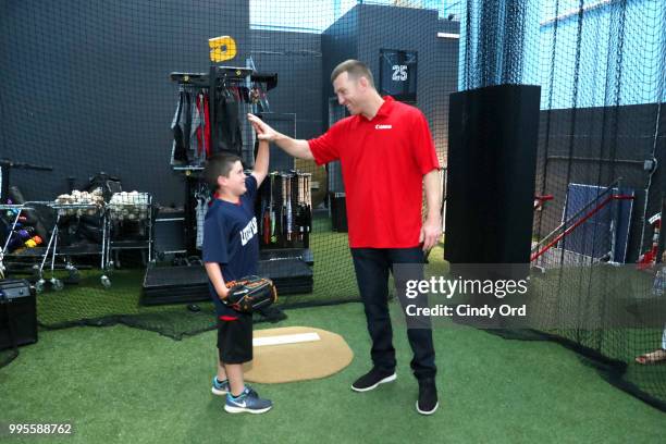 Todd Frazier and a player from the the Toms River Little League at the Canon #PIXMAPerfect Grand Slam event at New York Empire Baseball on July 10,...