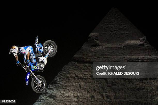 Freestyle biker jumps in front of the Giza pyramids during the second stage of the freestyle motocross Red Bull X-Fighters World Tour on the...