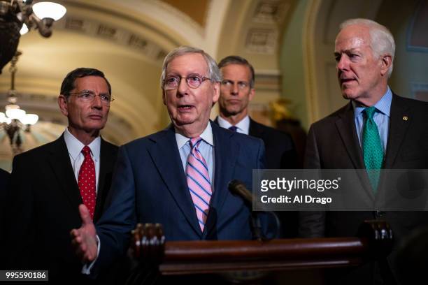 Senate Majority Leader Mitch McConnell speaks with fellow Senate Republicans during a news conference following the weekly Senate Republicans policy...