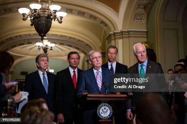 Senate Majority Leader Mitch McConnell speaks with fellow Senate Republicans during a news conference following the weekly Senate Republicans policy...