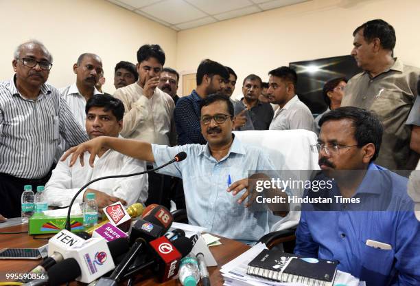 Delhi Chief Minister Arvind Kejriwal speaks as AAP MLA and vice-chairman of Delhi Jal Board Dinesh Mohaniya and CEO of Delhi Jal Board Anil Kumar...